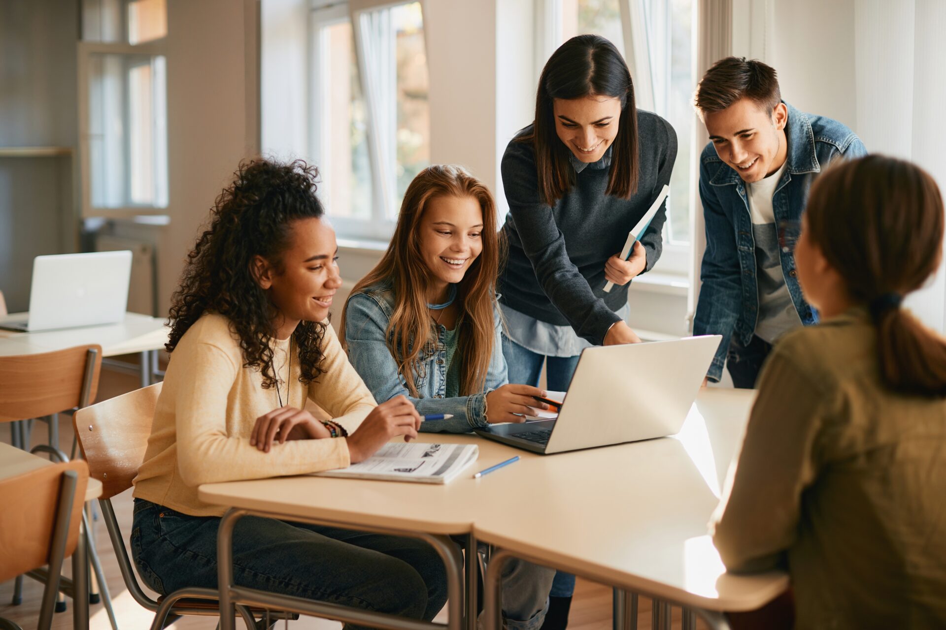 Teacher with Multiple HS Students and Laptop